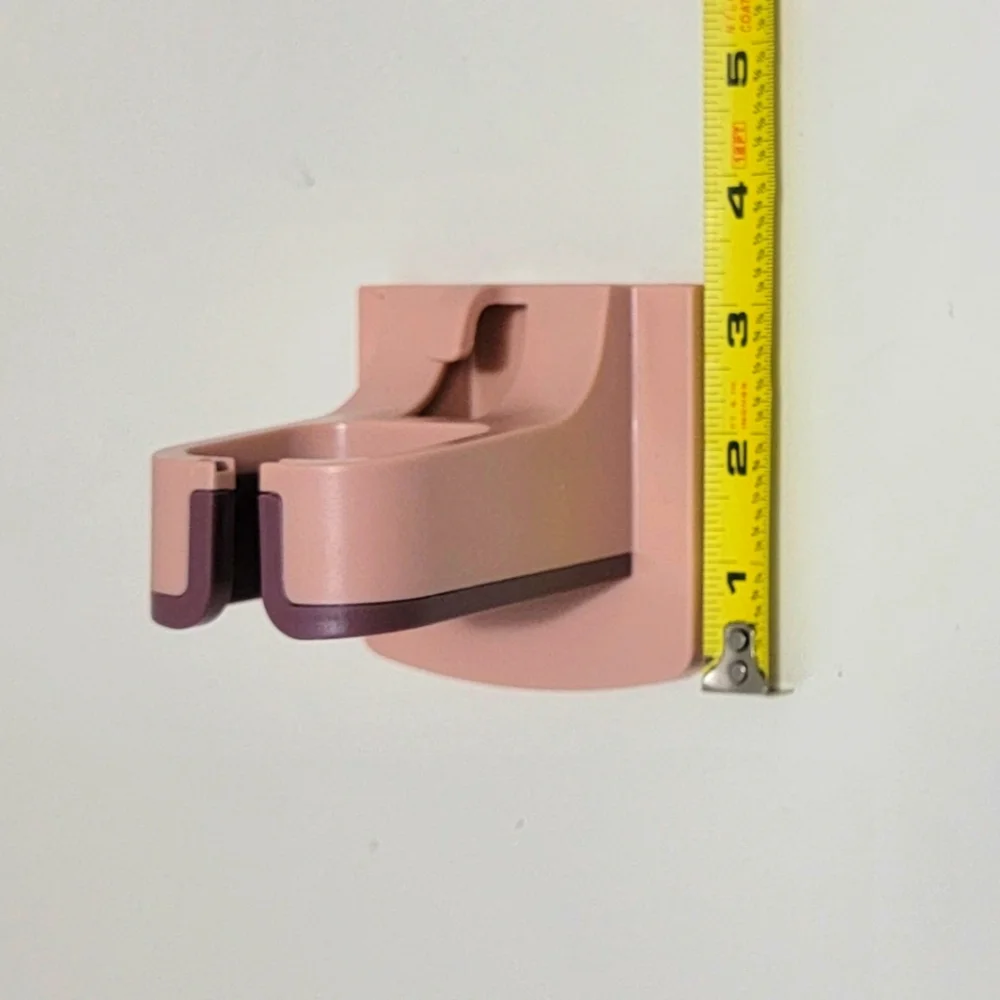 Pink and Purple Wall-Mounted Blow Dryer Holder.
